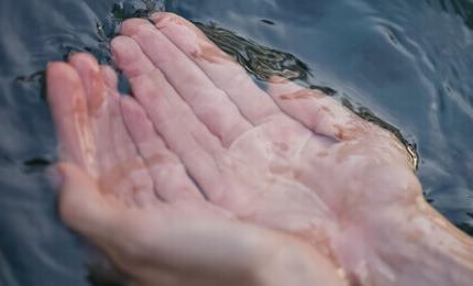 Close-up of hands taking water